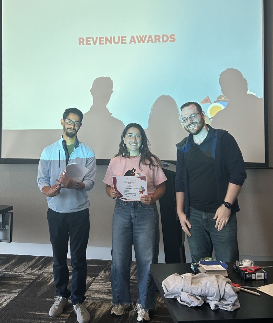 Annamarie holding her award certificate at BlastPoint's Revenue Awards